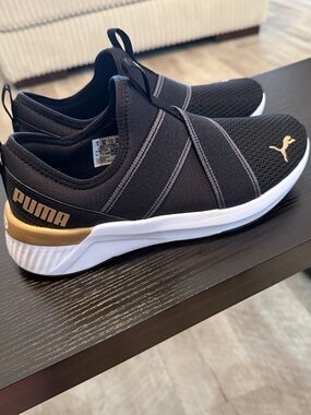 Puma women’s Black Slip-On Athletic Sneakers with Gold Accents